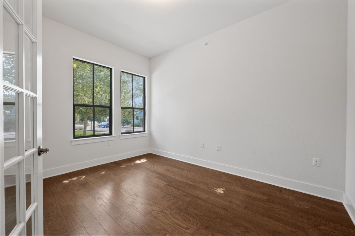3904 Teaff Street Austin, TX 78723 - Photo 13 of 33 a view of an empty room with wooden floor and a window