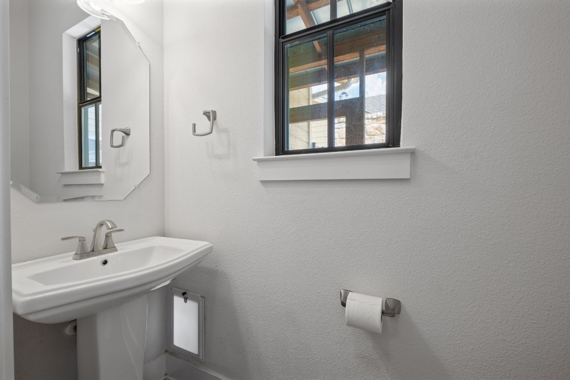 3904 Teaff Street Austin, TX 78723 - Photo 16 of 33 a bathroom with a sink and a mirror