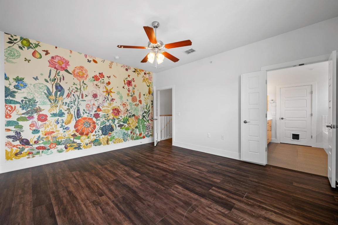 3904 Teaff Street Austin, TX 78723 - Photo 19 of 33 a view of an empty room with wooden floor and a painting on the wall