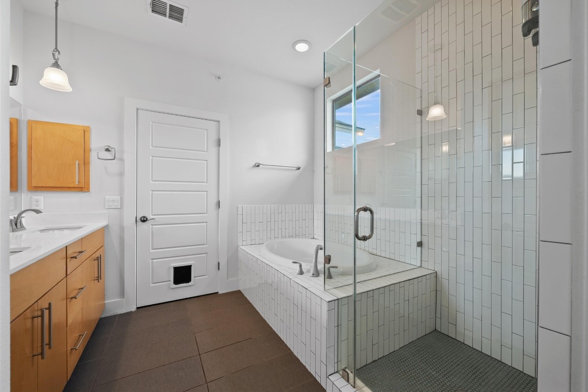 3904 Teaff Street Austin, TX 78723 - Photo 20 of 33 Step into the ensuite with a soaking tub, separate shower, and thoughtful finishes that make every day feel like a getaway