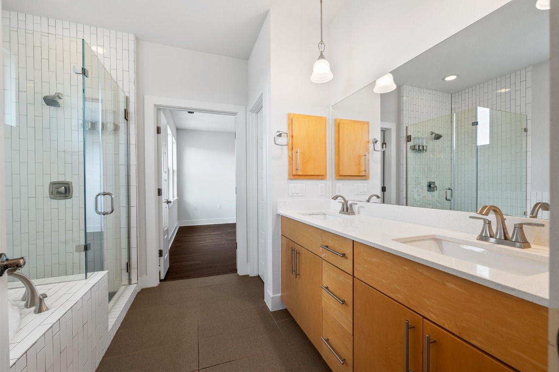 3904 Teaff Street Austin, TX 78723 - Photo 21 of 33 a spacious bathroom with a shower sink and mirror