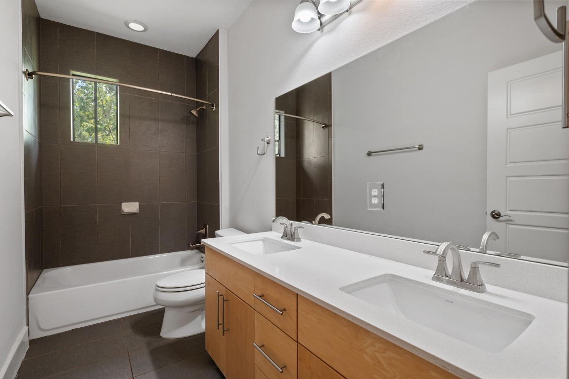 3904 Teaff Street Austin, TX 78723 - Photo 24 of 33 a bathroom with a granite countertop sink a toilet and shower