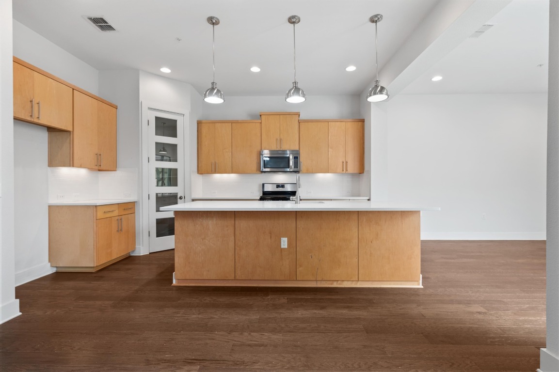 3904 Teaff Street Austin, TX 78723 - Photo 4 of 33 a large kitchen with stainless steel appliances granite countertop a sink a stove and a refrigerator