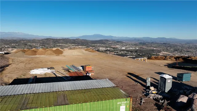an aerial view of a house yard and mountain view