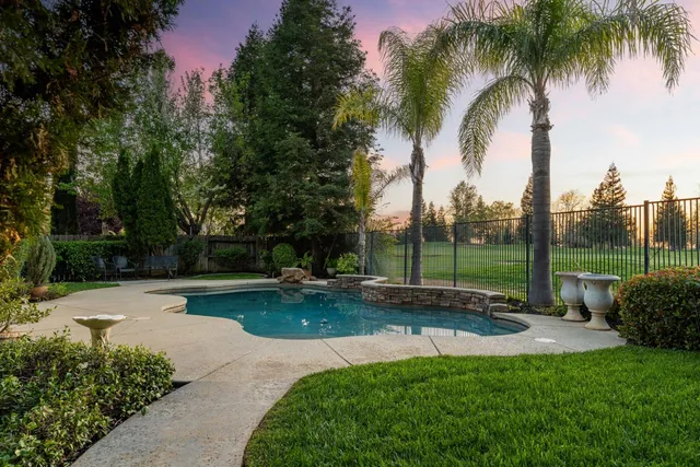 a front view of a house with a garden and garage