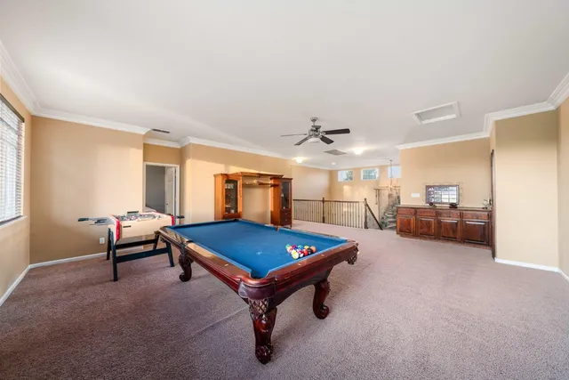 a backyard of a house with potted plants and trees