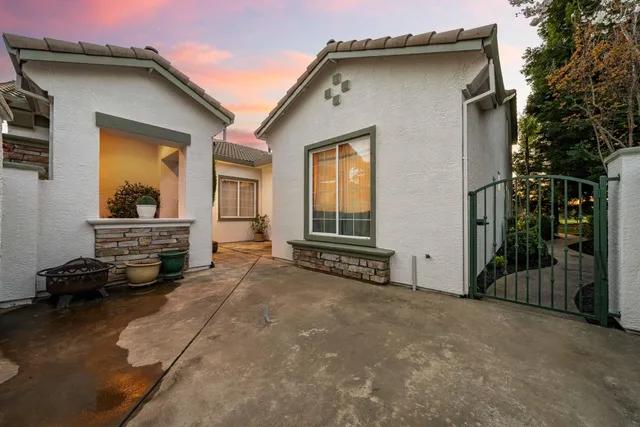 a front view of a house with a yard and mountain view in back
