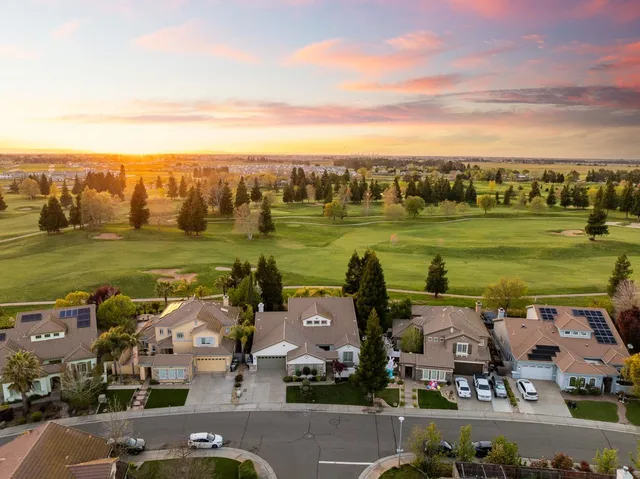 a aerial view of a house with a yard and balcony