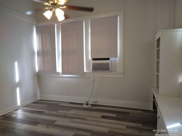 a room with window and hardwood floor
