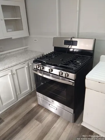 a stove top oven sitting inside of a kitchen