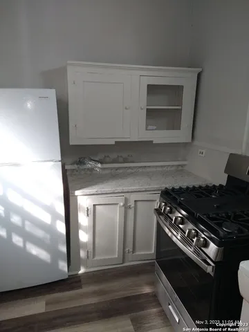 a kitchen with granite countertop a stove and a microwave