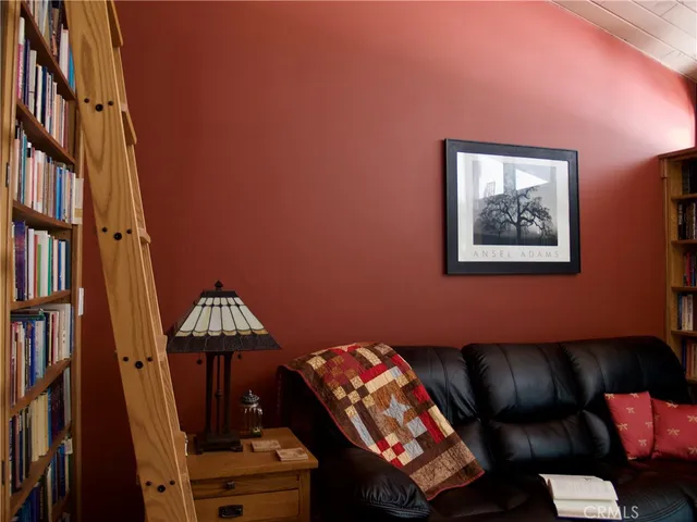 a living room with furniture and a piano