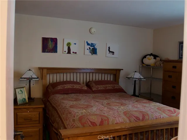 a bedroom with a bed and dresser