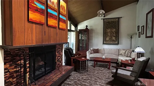 a living room with furniture a fireplace and a window