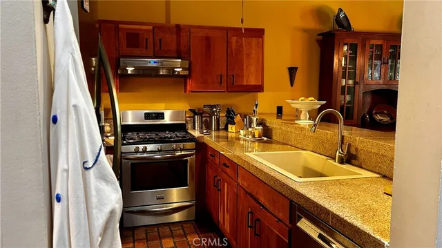 a kitchen with wooden cabinets and a stove top oven
