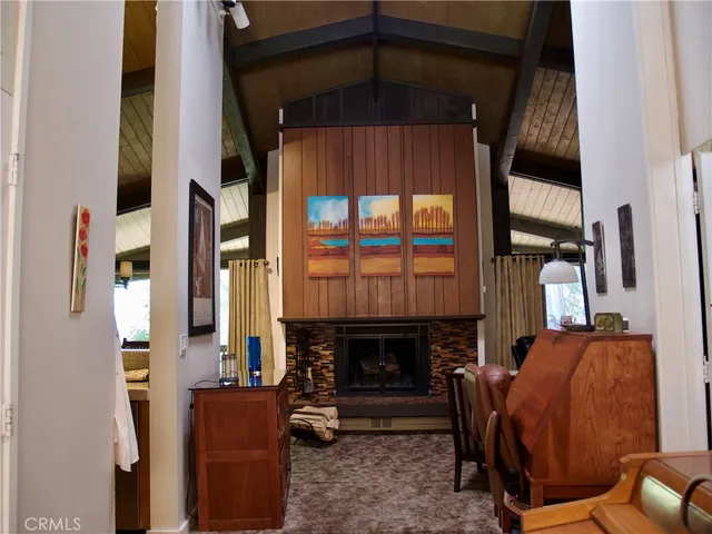 a living room with furniture a fireplace and a window