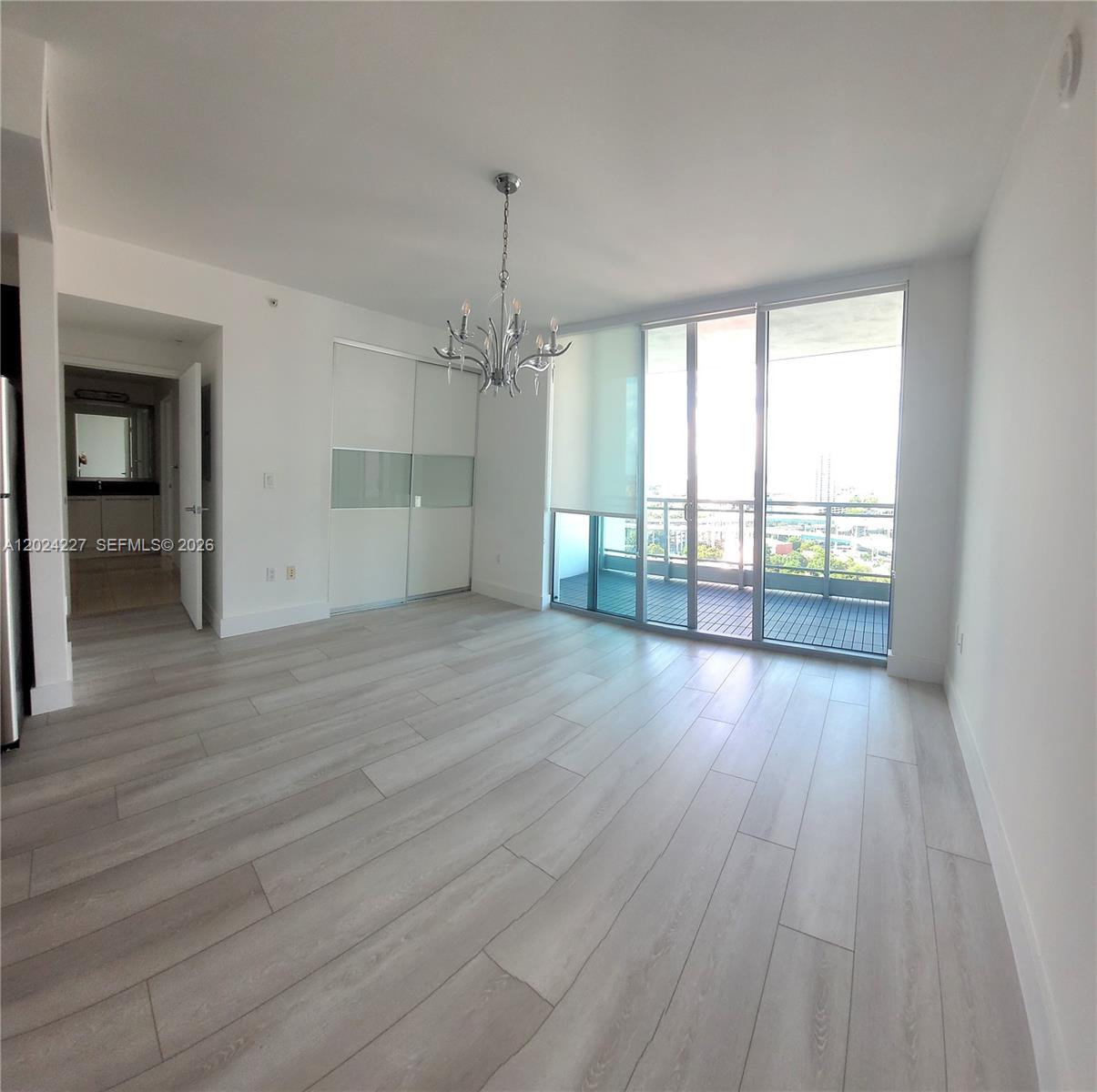 90 Southwest 3rd Street, Unit 2208 Miami, FL 33130 - Photo 14 of 56 an empty room with wooden floor and windows