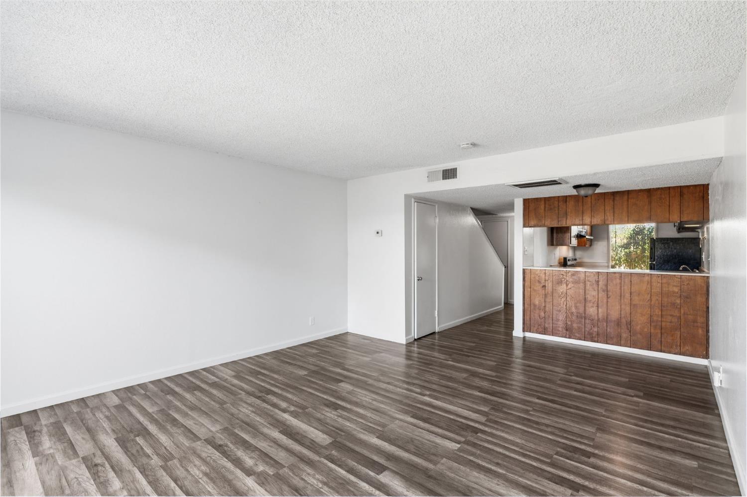 175 South 19th Avenue Lemoore, CA 93245 - Photo 12 of 42 a view of a room with wooden floor and a cabinet