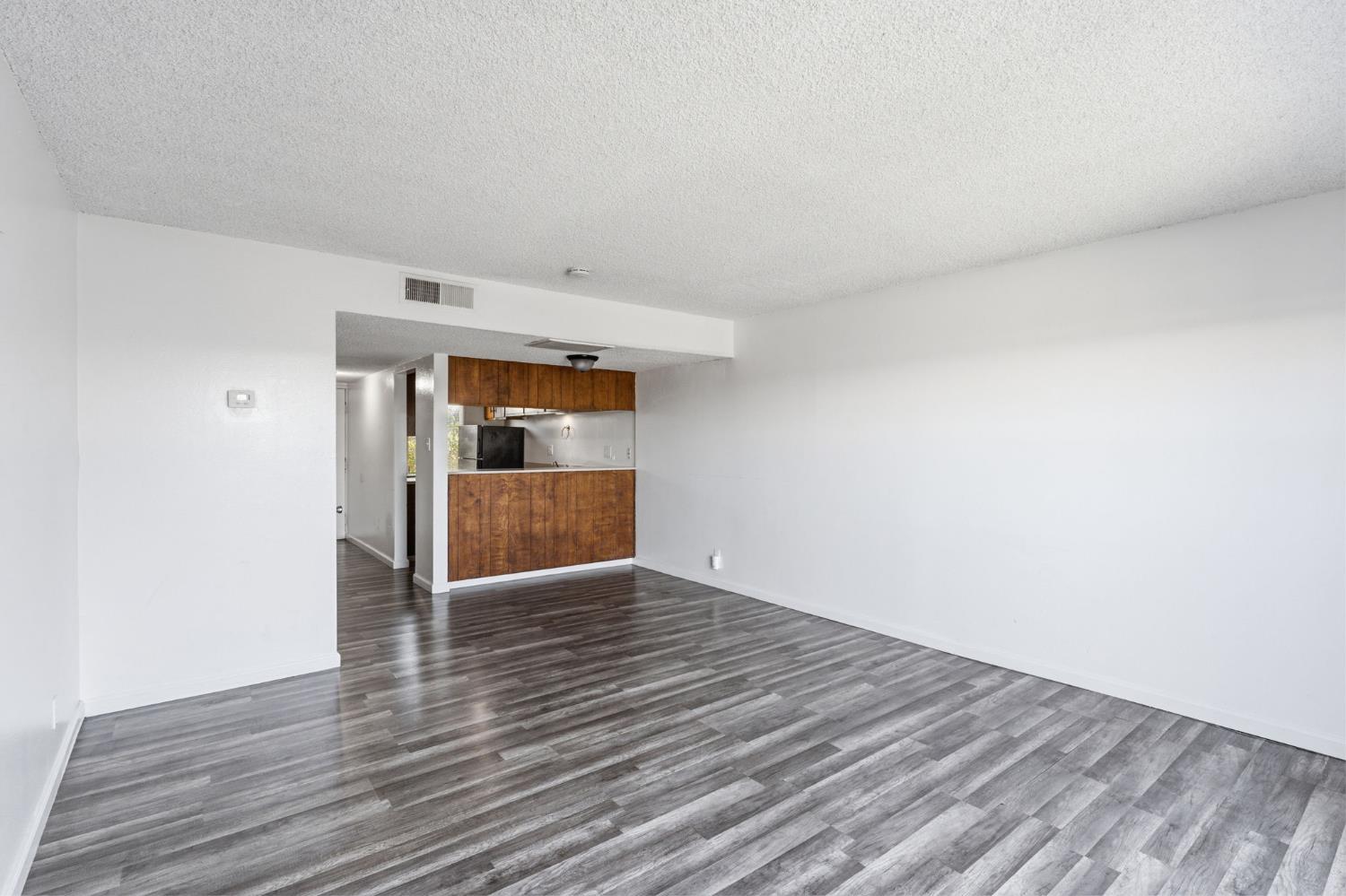 175 South 19th Avenue Lemoore, CA 93245 - Photo 13 of 42 a view of empty room with wooden floor