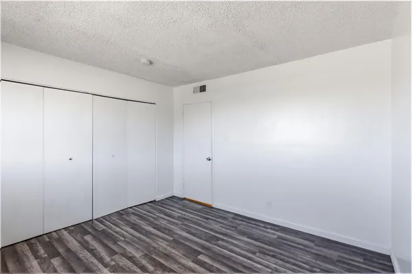 a view of a room with wooden floor and window
