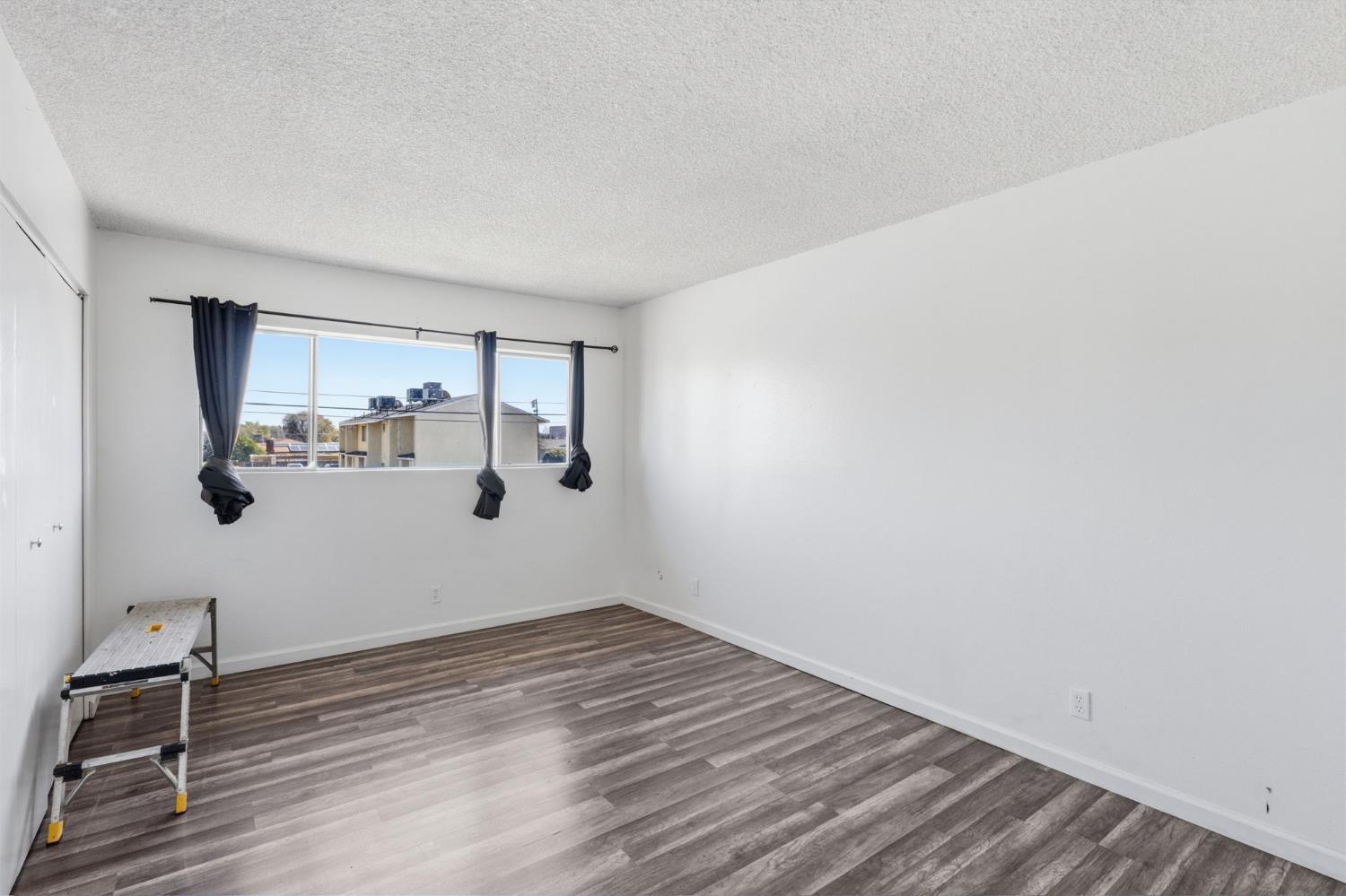 175 South 19th Avenue Lemoore, CA 93245 - Photo 18 of 42 a view of a room with wooden floor and window