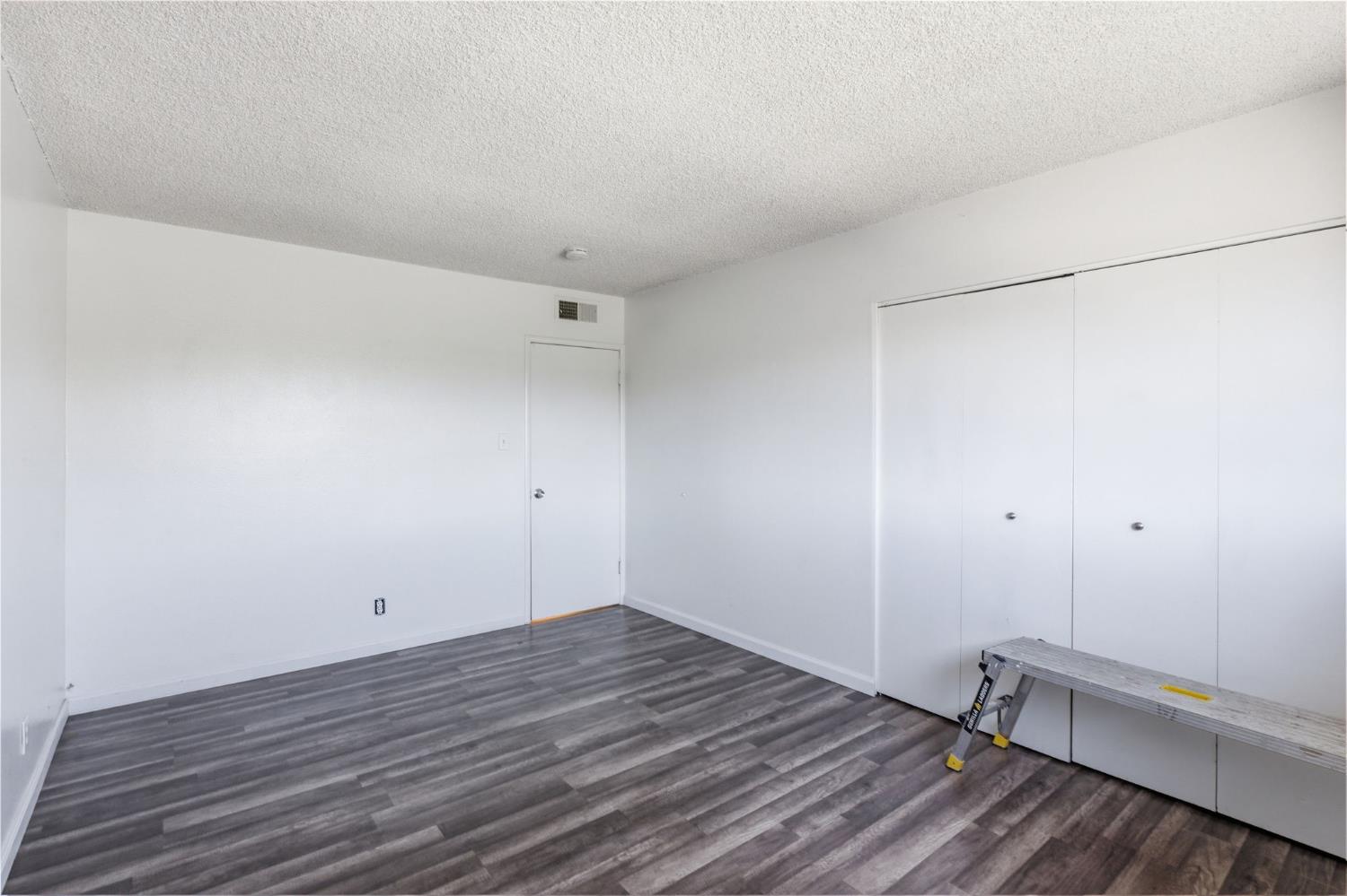 175 South 19th Avenue Lemoore, CA 93245 - Photo 19 of 42 a view of a room with wooden floor and white walls
