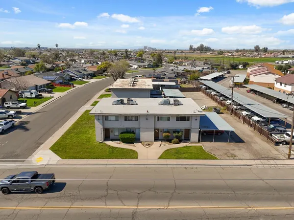 an aerial view of residential houses with outdoor space