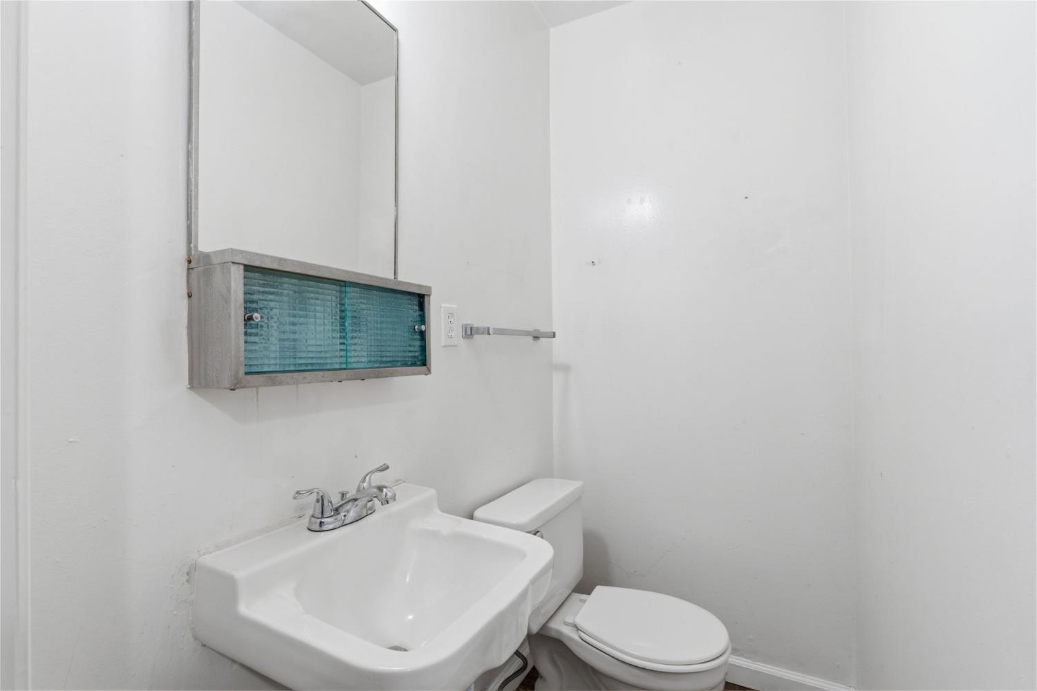 175 South 19th Avenue Lemoore, CA 93245 - Photo 6 of 42 a bathroom with a toilet sink and mirror