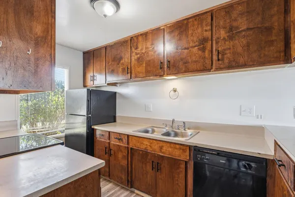 a kitchen with a sink a stove and cabinets