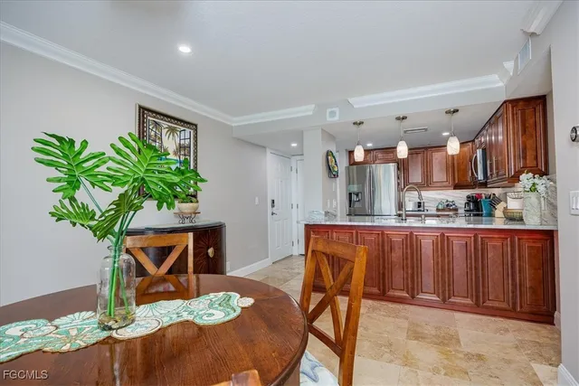 a dining room filled chandelier and wooden floor