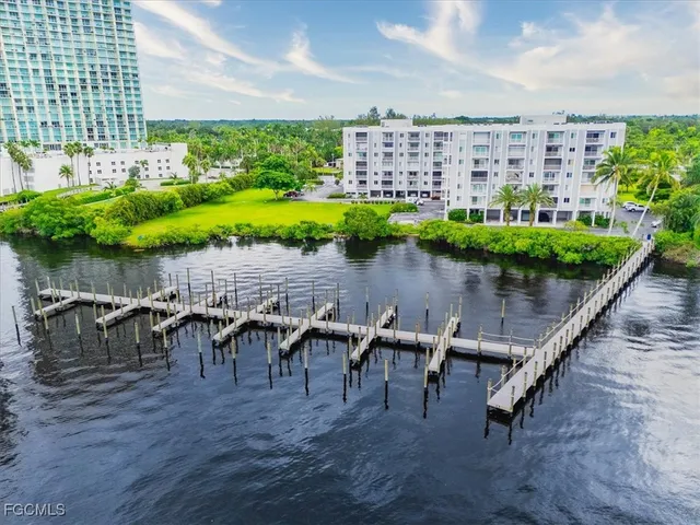 a view of a chairs and table in patio with swimming pool