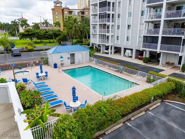a view of a swimming pool with a lounge chairs in front of main