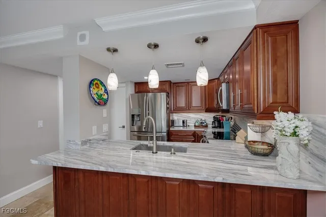 a kitchen with kitchen island granite countertop a sink cabinets and wooden floor