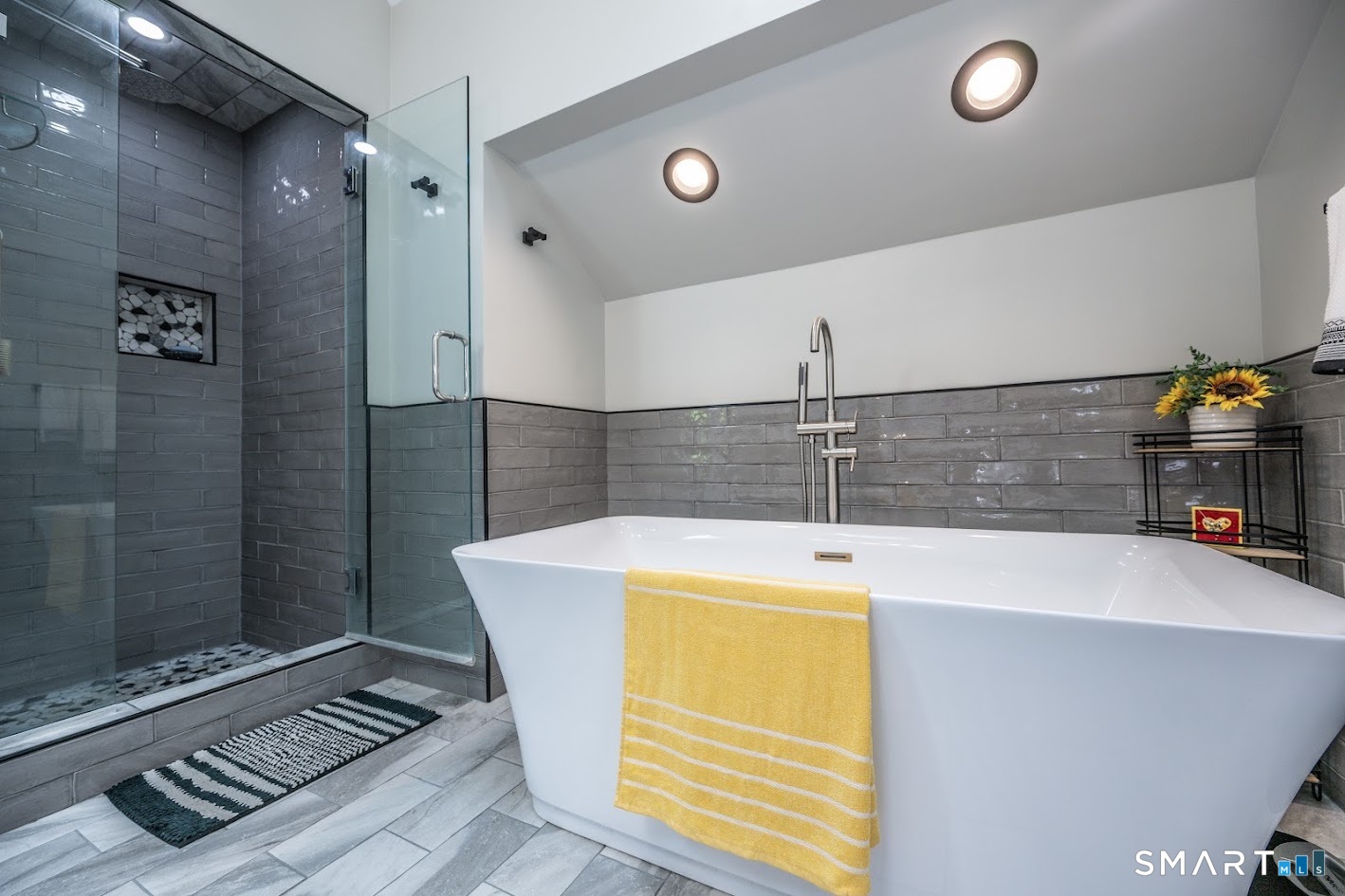 12 Ross Road Middlefield, CT 06481 - Photo 16 of 30 A primary bath that feels like your own private spa. Beautifully updated with a freestanding soaking tub, oversized tiled glass shower and sleek modern finishes, creating the perfect retreat at the end of the day.