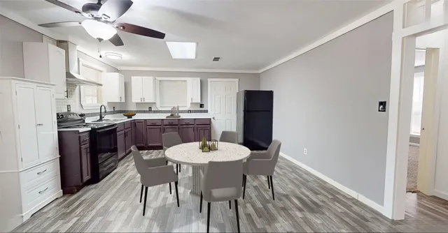 a kitchen with a dining table chairs stainless steel appliances and cabinets