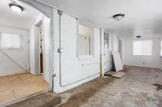 a view of a livingroom with wooden floor and a ceiling fan