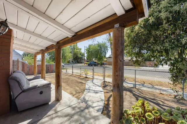 a view of the house with backyard and sitting area