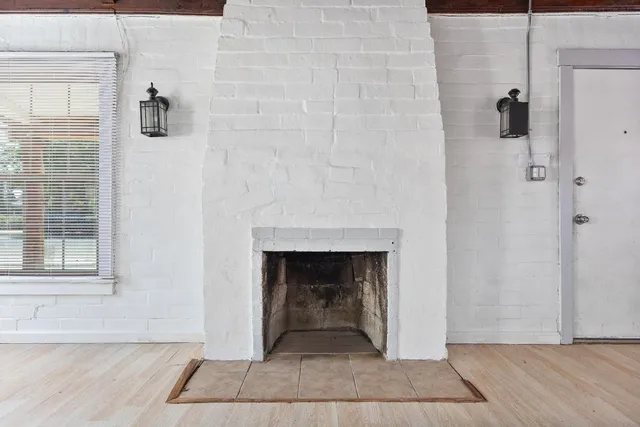 a living room with a fireplace and a rug