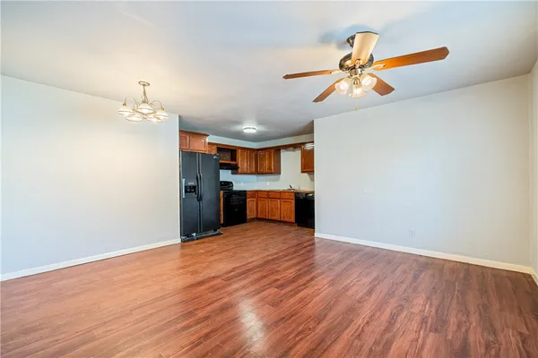 a view of a kitchen with a dishwasher and wooden floor