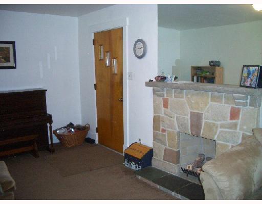 963 Stanford Road Brighton Heights, PA 15212 - Photo 2 of 8 Living Room. New beige carpet and freshly painted walls accent the attractive stone and tile fireplace and hearth.