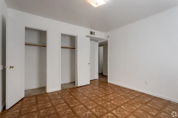 a view of a big room with closet and chandelier fan