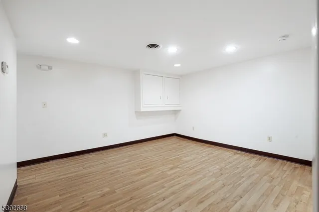 a view of a workspace with furniture and wooden floor