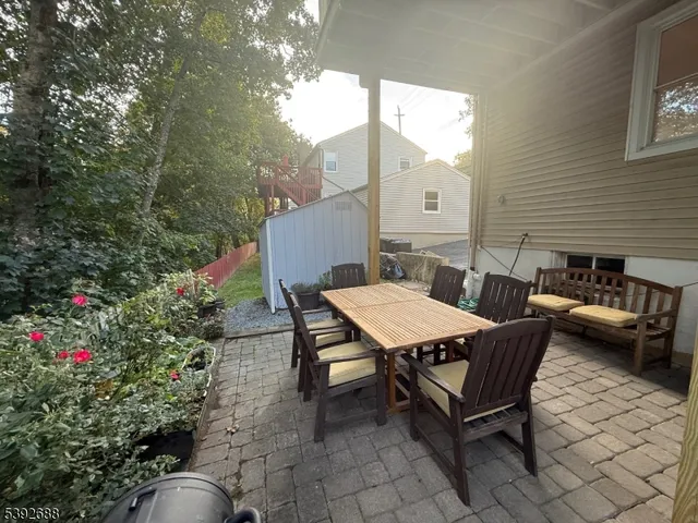 a view of a house with wooden deck front of house