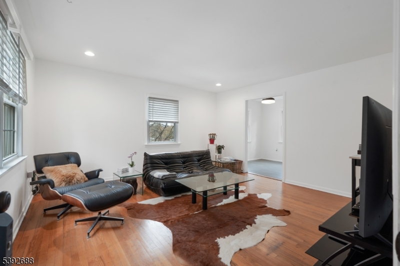 76 Mt Kemble Avenue, Unit 2 Morristown, NJ 07960 - Photo 7 of 23 a living room with furniture a rug and a flat screen tv