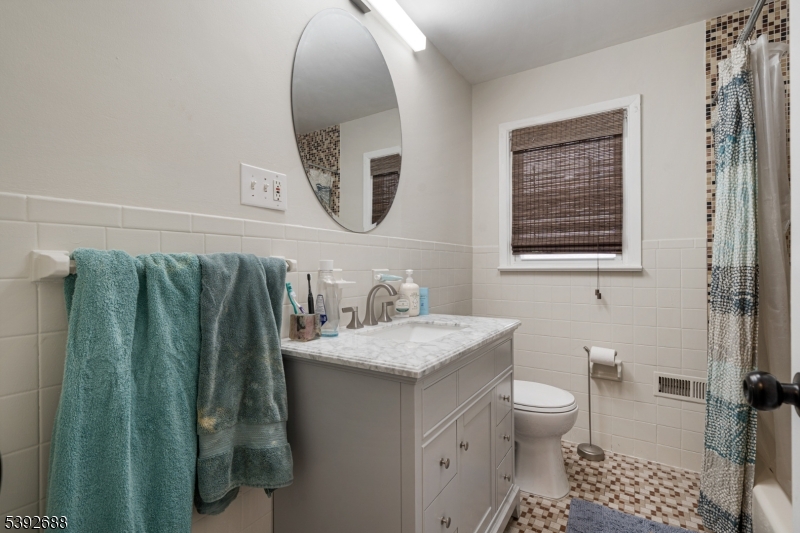 76 Mt Kemble Avenue, Unit 2 Morristown, NJ 07960 - Photo 10 of 23 a bathroom with a granite countertop sink and a mirror