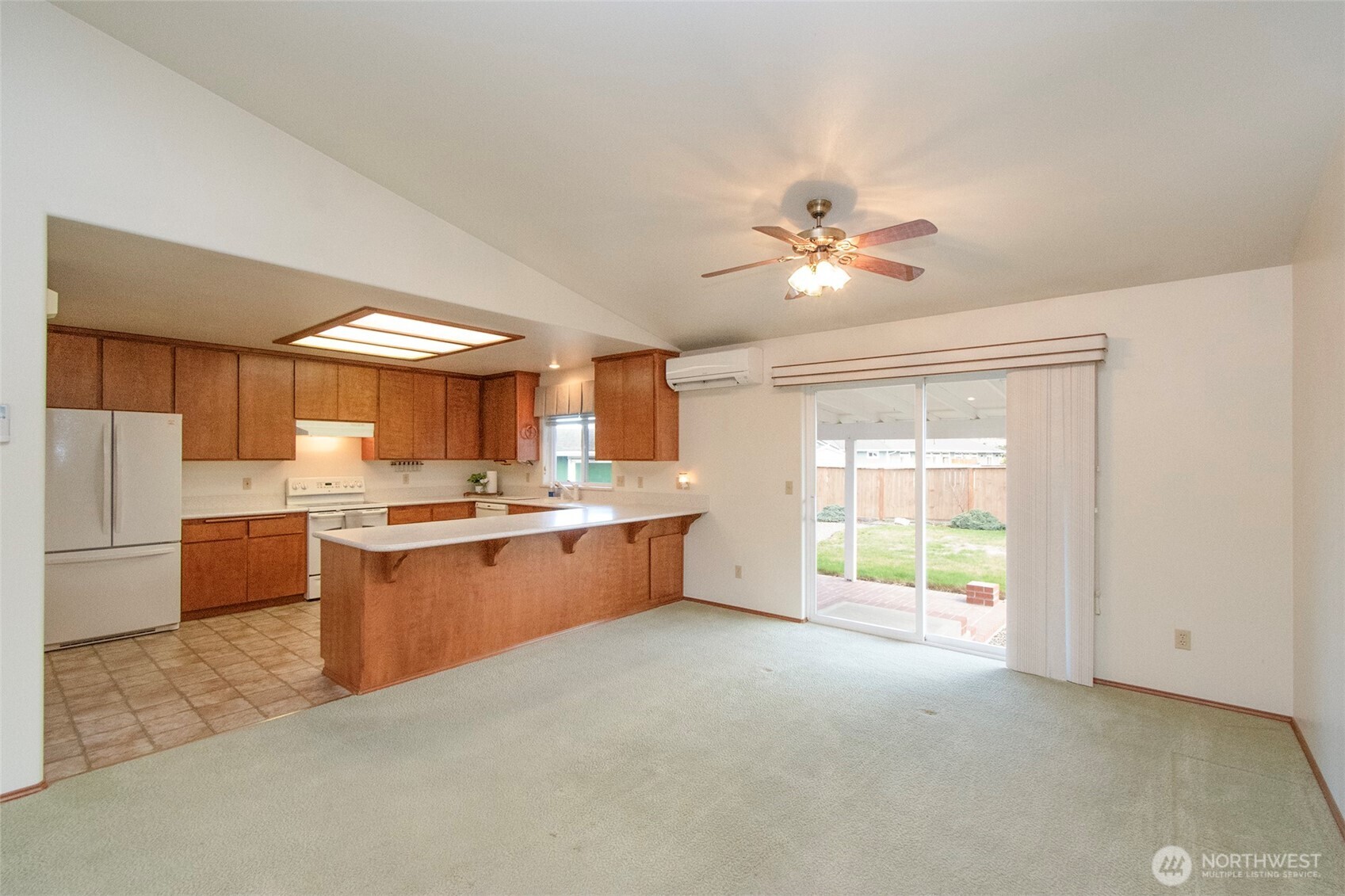 151 Duke Drive Sequim, WA 98382 - Photo 7 of 39 a large kitchen with stainless steel appliances a stove a refrigerator a sink dishwasher with a dining table and chairs