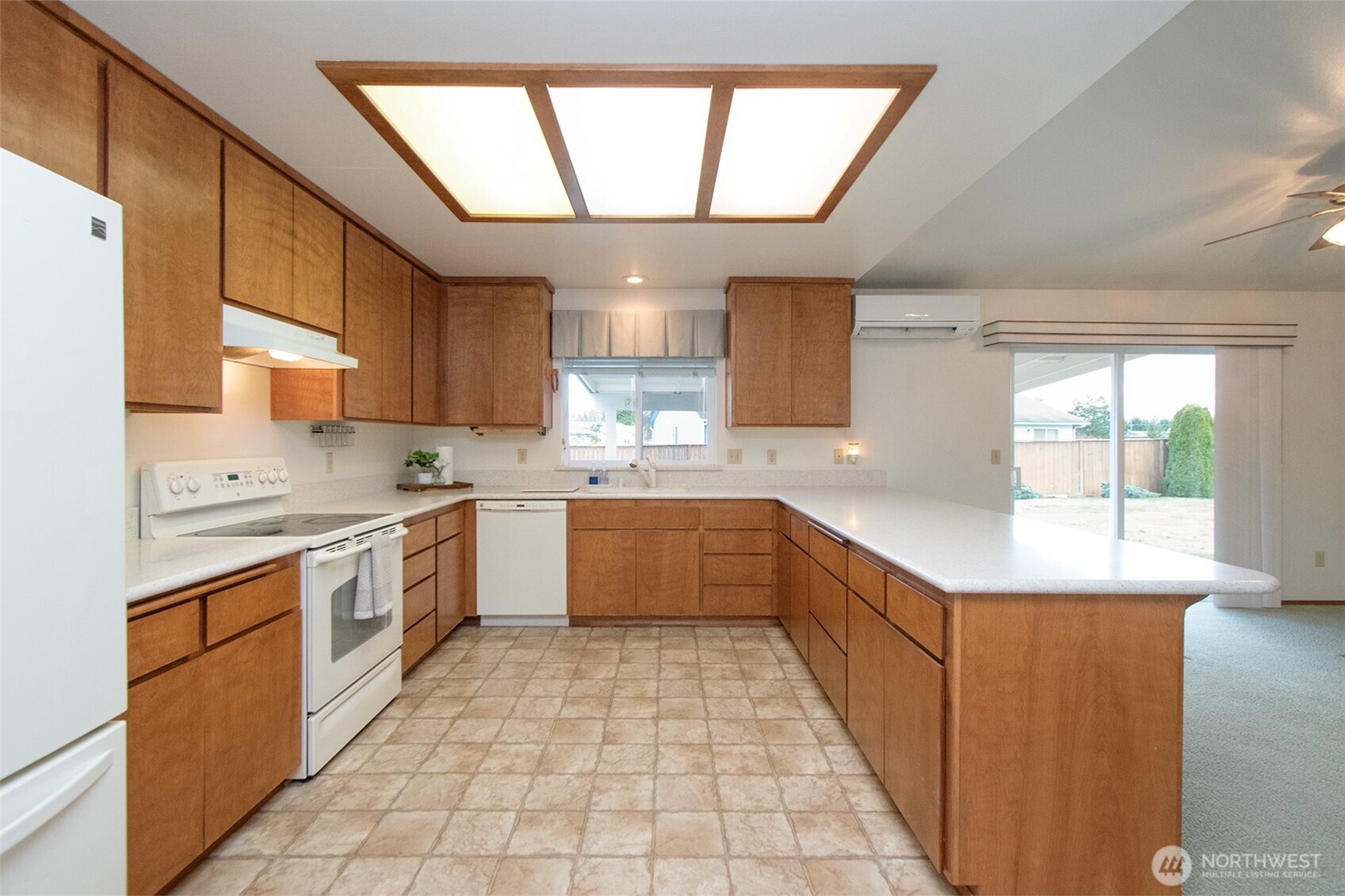 151 Duke Drive Sequim, WA 98382 - Photo 9 of 39 a large kitchen with stainless steel appliances granite countertop a sink counter space cabinets and a large window