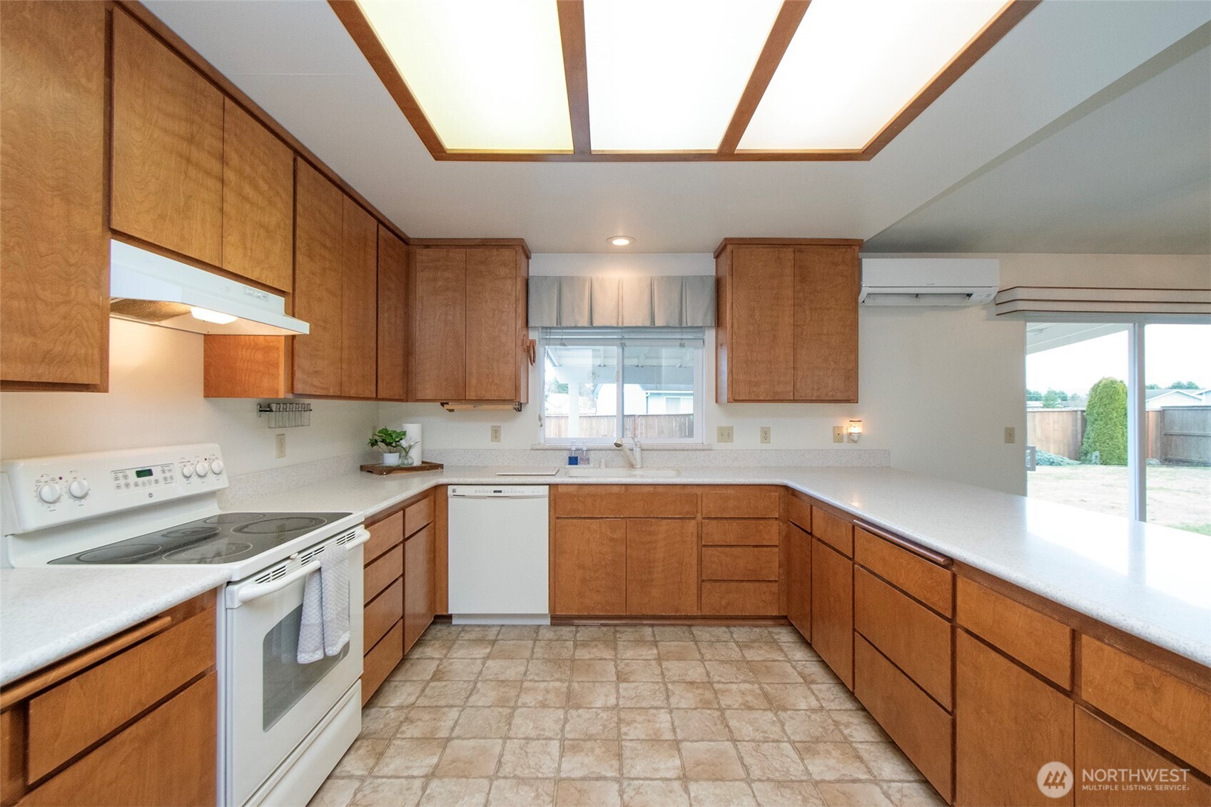 151 Duke Drive Sequim, WA 98382 - Photo 10 of 39 a kitchen with a sink window and cabinets