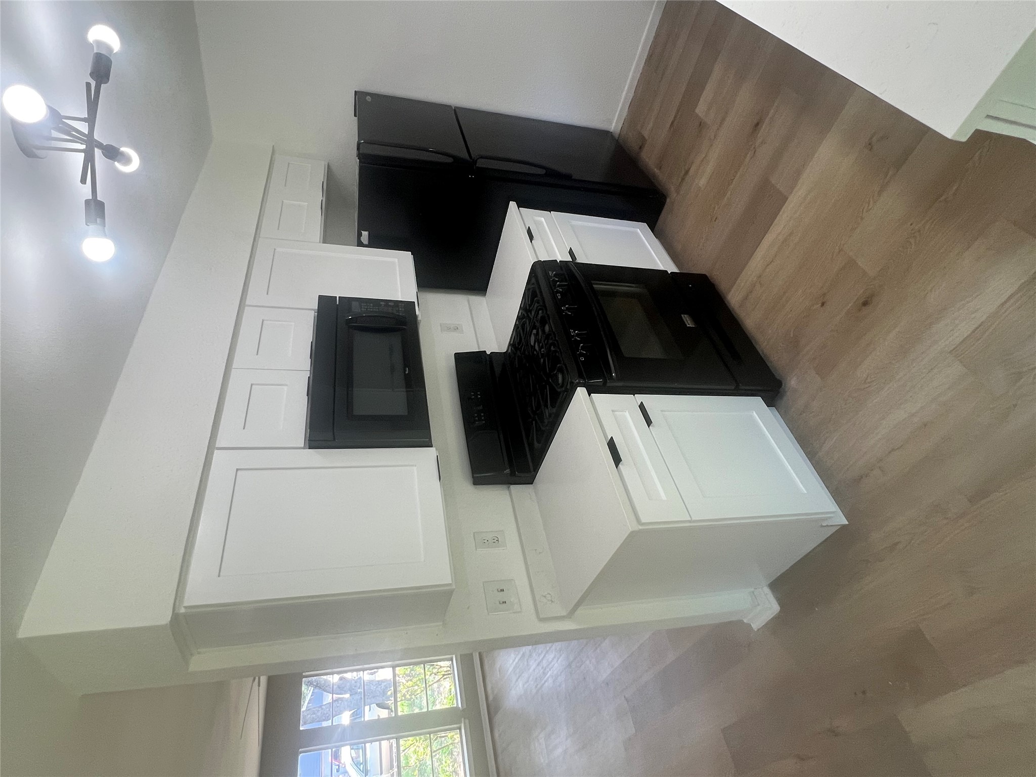 4620 Button Bend Road Austin, TX 78744 - Photo 6 of 22 A well-equipped kitchen featuring contemporary cabinetry and a clean aesthetic.