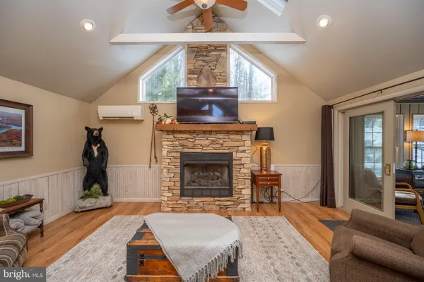 a kitchen with stainless steel appliances a dining table chairs stove refrigerator and cabinets